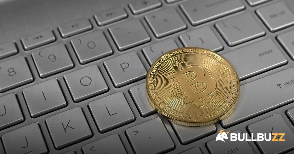 Physical Bitcoin coin on laptop keyboard as hacker swaps stolen ETH to BTC