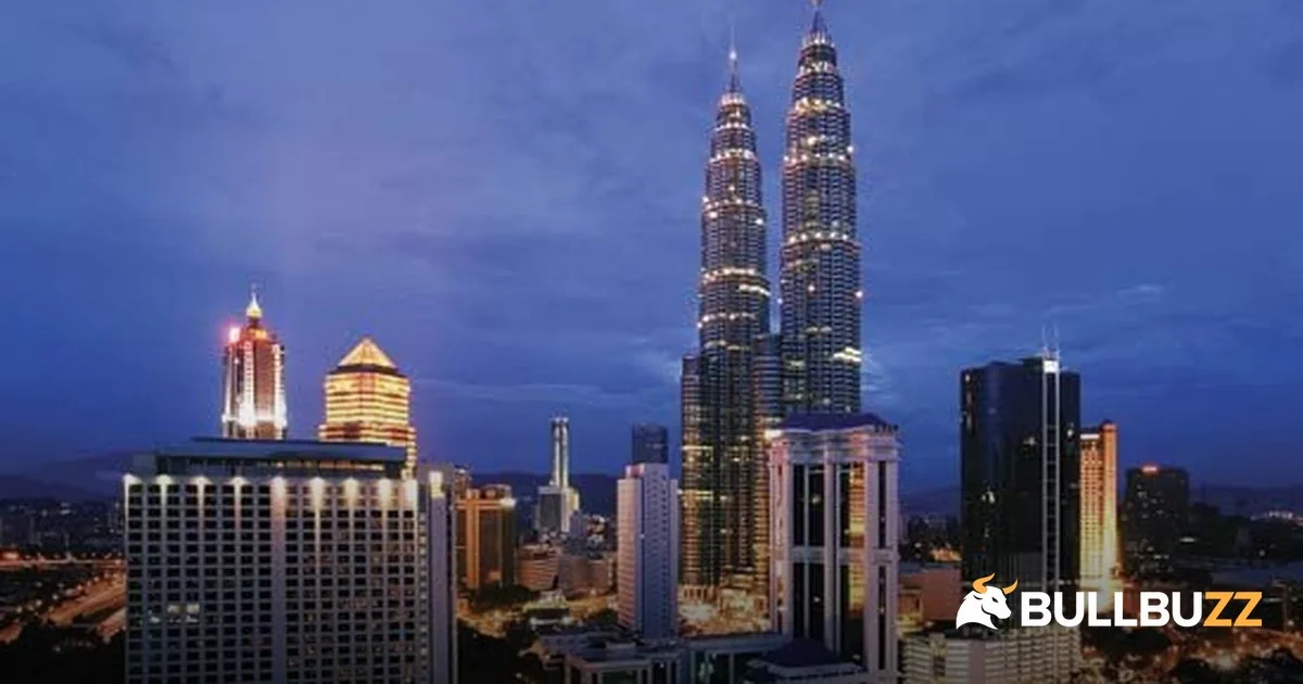Kuala Lumpur skyline at dusk with Petronas towers as Bursa KLCI closes lower