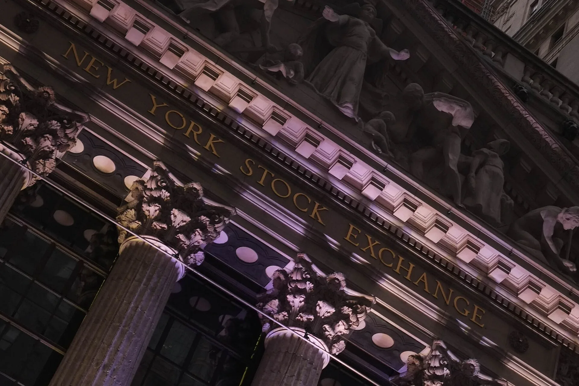 New York Stock Exchange facade at night as Robinhood announces 24-7 weekend stock trading