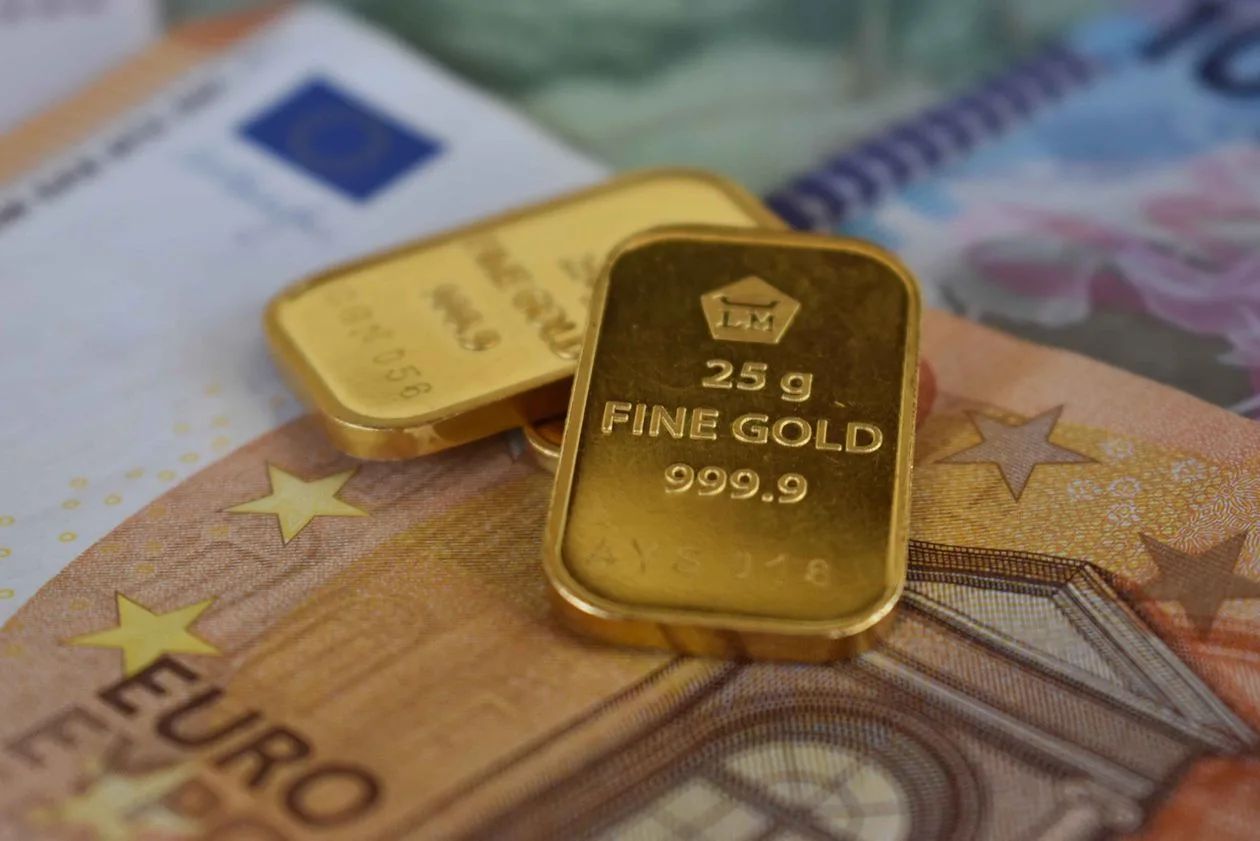 Gold bars on euro banknotes as gold price slips to $4,129 on ISM inflation signal