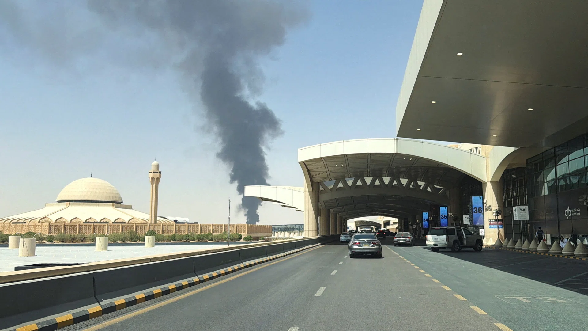 Smoke rises near a Riyadh airport terminal as Saudi airport attacks escalate